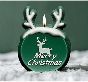 Detalle de la vela navideña verde con diseño de alce y texto de Merry Christmas