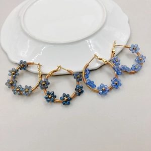 Handmade beaded crystal flower hoop earrings with blue stones on golden wire wrap