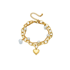 Double-layered gold chain bracelet with pearl accents and a smooth heart charm