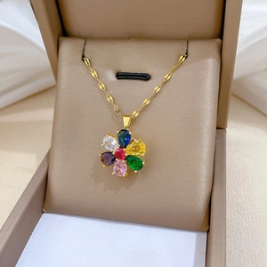 Close-up of a rotating six-petal flower pendant with colorful cubic zirconia in a jewelry box