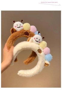 Detail of plush caterpillar headbands in brown and white with soft fuzzy texture