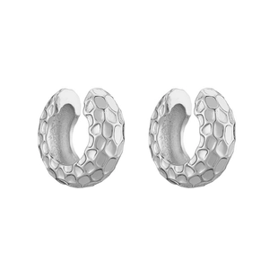 Macro detail of silver C-shaped ear cuff featuring a textured honeycomb hammered finish