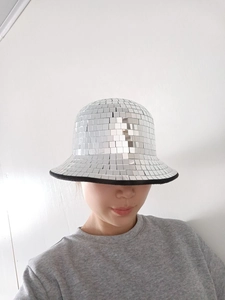 Detail of silver disco ball bucket hat with mirror tiles and black fabric trim