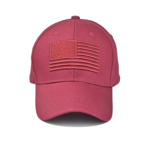 Detailed close-up of dark red washed cotton baseball cap with American flag embroidery