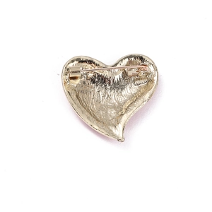Detail view of the gold alloy heart brooch back showing the pin and secure rotating clasp