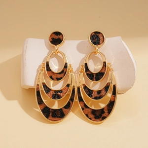 Detail of leopard print faux fur inset in gold multilayer hollow round drop earrings