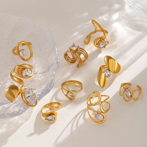 Detailed view of gold irregular zircon rings with elegant shadows on warm background