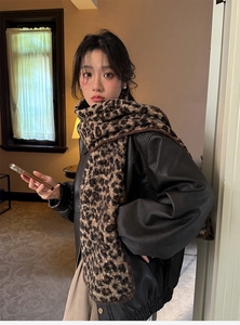 Leopard print faux wool scarf styled with a black leather jacket for a chic winter look