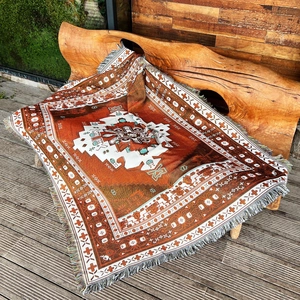 Detailed view of bohemian woven blanket with geometric patterns and fringe edges