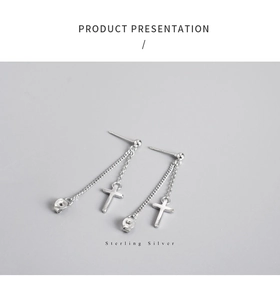 Detail view of sterling silver cross drop earrings with fine chain and polished finish