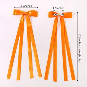 Double-layered orange satin bow hair clips with long ribbons and metal alligator clips