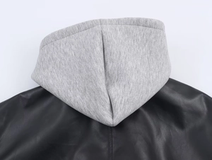 Close-up of the hooded back stitching and mixed leather effect texture on a black jacket