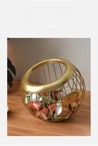 Detail of gold metal coffee capsule storage basket with an open tilted design