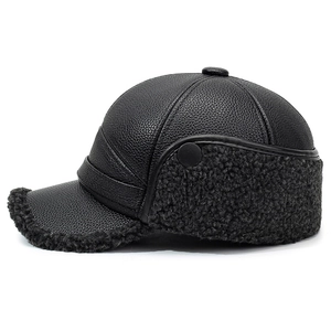 Detail of leather baseball cap with faux fur earflaps and pebbled texture for men