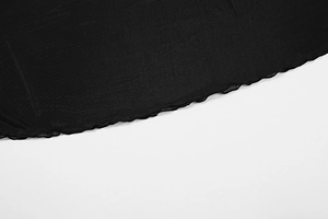 Detail of elegant black mesh dress featuring wavy lettuce hem and fine stitching details