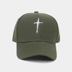 Detailed close-up of army green cotton baseball cap with white cross embroidery
