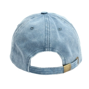 Macro shot of washed blue cotton denim baseball cap with vintage adjustable bronze metal buckle