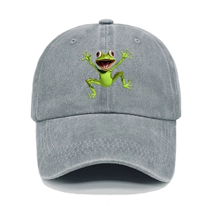 Close-up of a washed grey denim baseball cap with an embroidered green frog patch