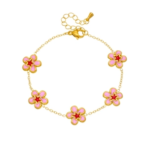 Detail of gold chain bracelet with five pink floral charms and lobster clasp