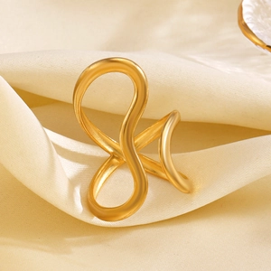 Minimalist 18K gold plated stainless steel crisscross ring on silk fabric
