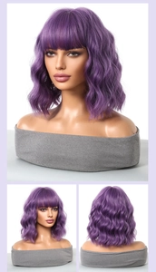 Detail view of purple short wavy bob wig with flat bangs on a mannequin head stand