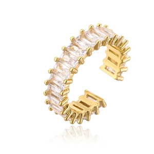 Macro detail of adjustable gold ring with emerald cut zircon stone settings