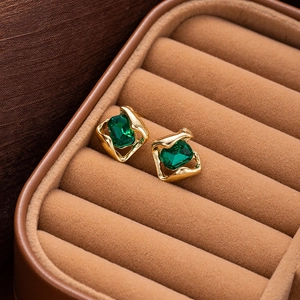 French vintage gold studs with large emerald green rectangular crystal on velvet