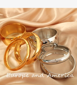 Polished titanium steel bracelets in gold and silver on premium champagne silk fabric