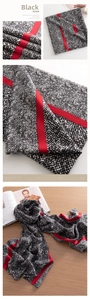 Macro detail of snake print cashmere-feel scarf with black weave and red stripe