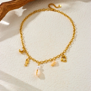 Gold stainless steel ocean necklace featuring dolphin, seahorse, shell and pearl charms