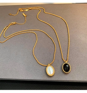French vintage necklaces with black onyx and white mother of pearl oval pendants