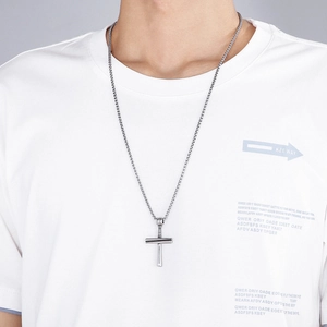 Men's titanium steel cross necklace with silver pendant on a model in a casual style