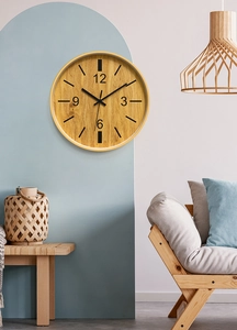 Minimalist 12-inch wall clock with bamboo texture finish on a blue arched feature wall