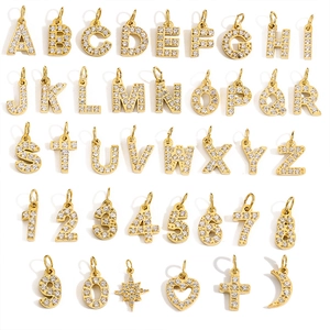 Detailed grid layout of gold stainless steel alphabet and number charms with zircon inlay