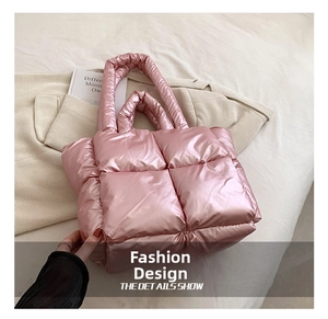 Close-up of pink quilted puffer tote bag with glossy satin finish and padded handles