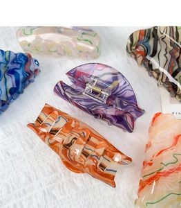 Detail of artistic oil painting style acrylic hair claws with marble patterns and textures