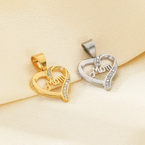 Gold and silver heart MOM pendants with rhinestones on silk fabric background