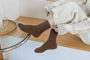 Detail of dark brown coral fleece mid-calf socks worn for winter warmth and comfort