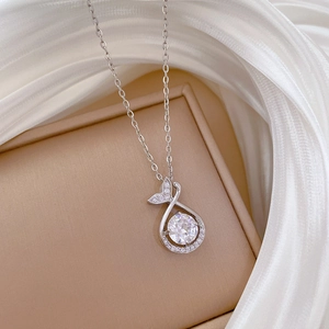 Close-up of silver mermaid tail pendant featuring sparkling crystals and large round zircon