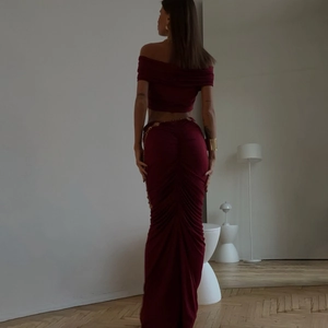Back view of burgundy slim fit crop top and ruched maxi skirt set with elegant tailoring