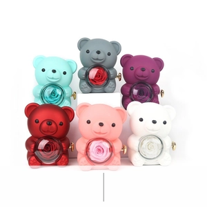 Rotating teddy bear music boxes with preserved roses in six colors on white background