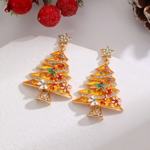 Close-up of gold Christmas tree earrings with orange rhinestones and star pendants
