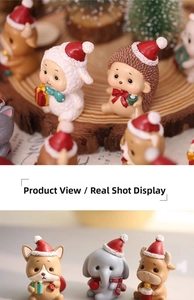 Close-up of resin Christmas animal figurines featuring cute dogs and sheep with red hats