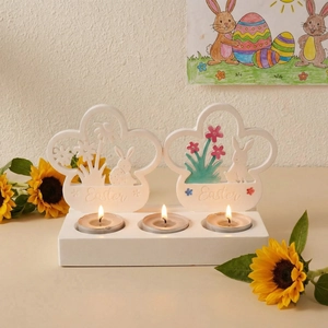 Detail of three-hole Easter bunny tea light candle holder with warm lit candles