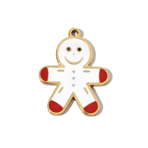 Detailed macro view of a gingerbread man pendant with red and white enamel on gold plating
