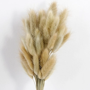 Detailed view of fluffy dried reed flowers and bunny tails in a natural cream bouquet