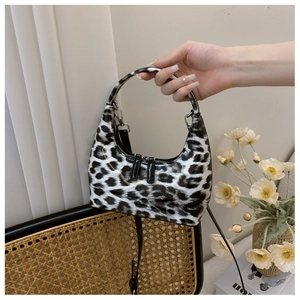 Detail of glossy leopard print patent leather handbag with premium metal zipper detail