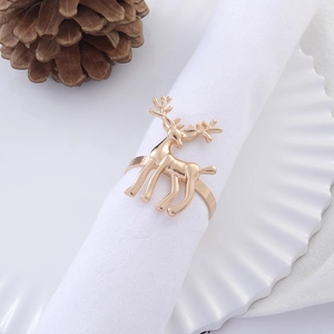 Golden reindeer alloy napkin ring on a white cloth for festive holiday table setting