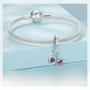 Close-up of S925 silver mesh bracelet with heart-shaped cherry pendant and LOVE clasp