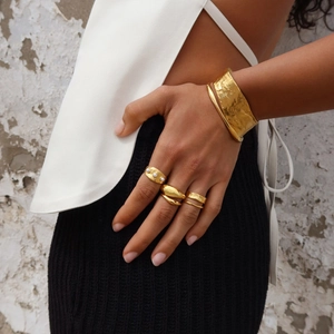 Gold plated titanium steel ring and cuff set with imitation pearls on a model